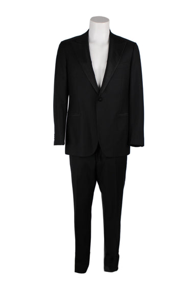 suitsupply black 'lazio' two piece tuxedo. jacket features one button single breasted closure, silk covered peak lapel, silk trimmed jetted pockets, boat shaped breast pocket, and four button cuffs. trousers feature flat front, silk trimmed stripe down leg outseam, invisible double hook with zip fly closure, jetted-button back pockets, slanted side pockets, and inner buttons for attaching breaches.  