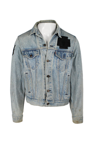 reformation upcycled / re-done levi's light wash denim jacket. sold as is. see last images. features contrasting black experimental leather appliques, collared neckline, buttoned chest pockets, slit waist pockets, branded button closure along front. 