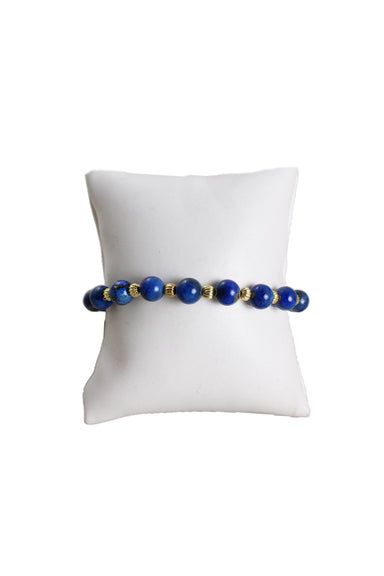 unlabeled 'blue lapis' beaded bracelet with gold tone beads on a stretch band for adjustable fit. 
