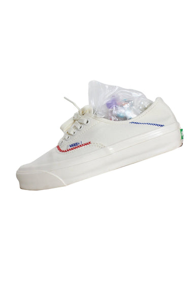 description: vans madhappy x marshmallow off-white canvas darning sneakers. features rounded toe silhouette, lace up closure, "madhappy vans" is stitched on the tongue in red, blue, green, and yellow. comes with box, extra laces, and set of beads.