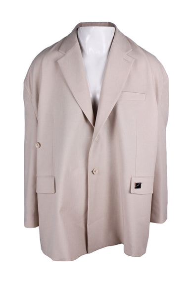 we11done beige blazer. features single-breasted fit, notch lapels, dropped shoulders, flap waist pockets (branded silver & black pin at right pocket) welt chest pocket, double button closure along front. 