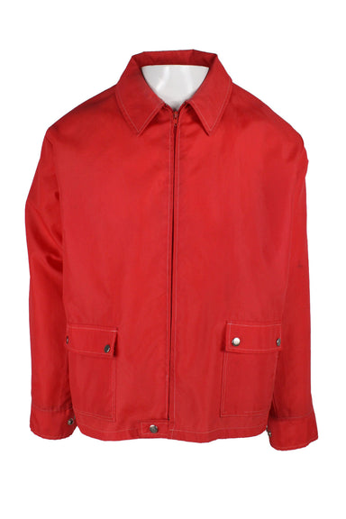 unlabeled red shell jacket featuring a classic collar, tonal zip closure, white topstitching, silver tone snap button closures, flap pockets at the lower front and a boxy fit. 