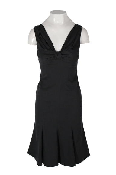 moschino cheap and chic black sleeveless short dress. features a v neckline and back, pleated details, a zipper closure at the left side seam, and a conceptual fishtail style.