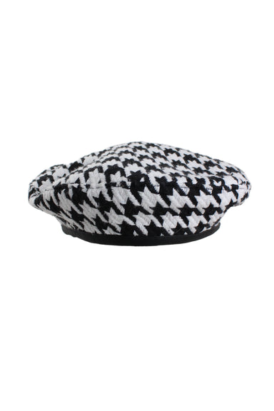 unlabeled black and white houndstooth beret featuring black leather style trim, medium sized houndstooth pattern and lined interior. 