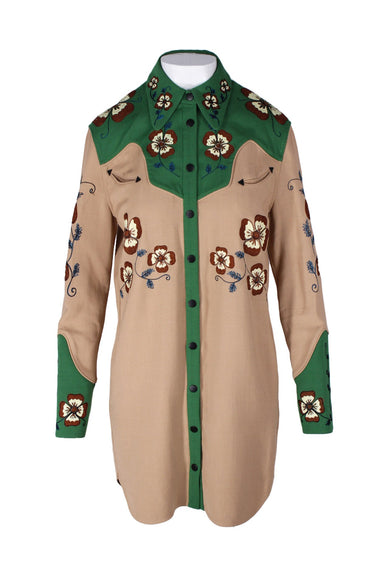 coach green and beige embroidered western influence shirt dress. features symmetrical floral embroidery throughout, snap button closure up entire center, pointed collar, long sleeves, seven snap cuffs, side slit pockets, and western style green panels around shoulders/at cuffs. 