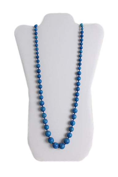 vintage unlabeled blue stone beaded necklace. features knotted strand, natural dyed stones in gradient shape, and over the head fit. 