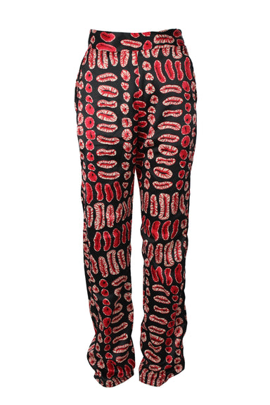 grass fields black and red print pants. features african print throughout, slash pockets, and zip closure at left side.